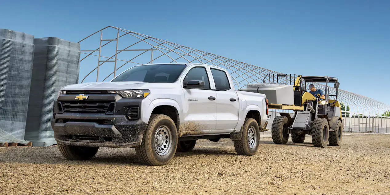 Chevrolet Colorado WT crew cab at a construction site with a compact loader