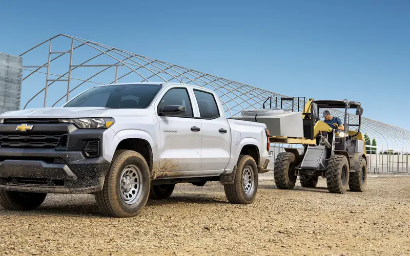 Chevrolet Colorado WT crew cab at a construction site with a compact loader