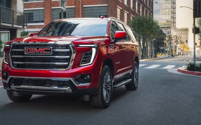 GMC Yukon in red on a city street