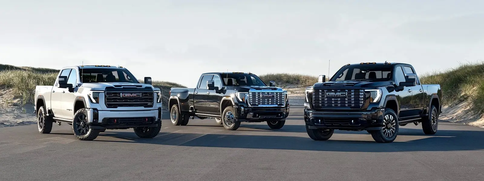 Three GMC Sierra HD pickups parked side by side