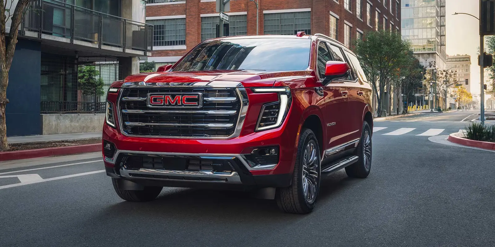 GMC Yukon in red on a city street