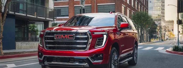 GMC Yukon in red on a city street