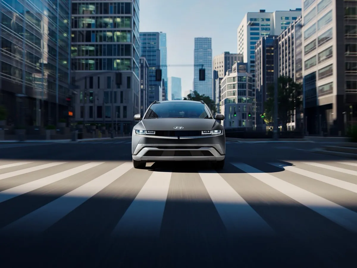 Gray 2027 Hyundai IONIQ 5 driving through a city crosswalk