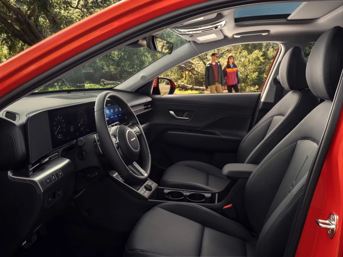 Front seats of a 2027 Hyundai Kona seen through the open door