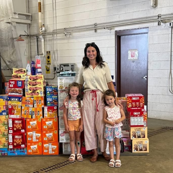 Alesha Buzzell and her daughters with donated snack supplies