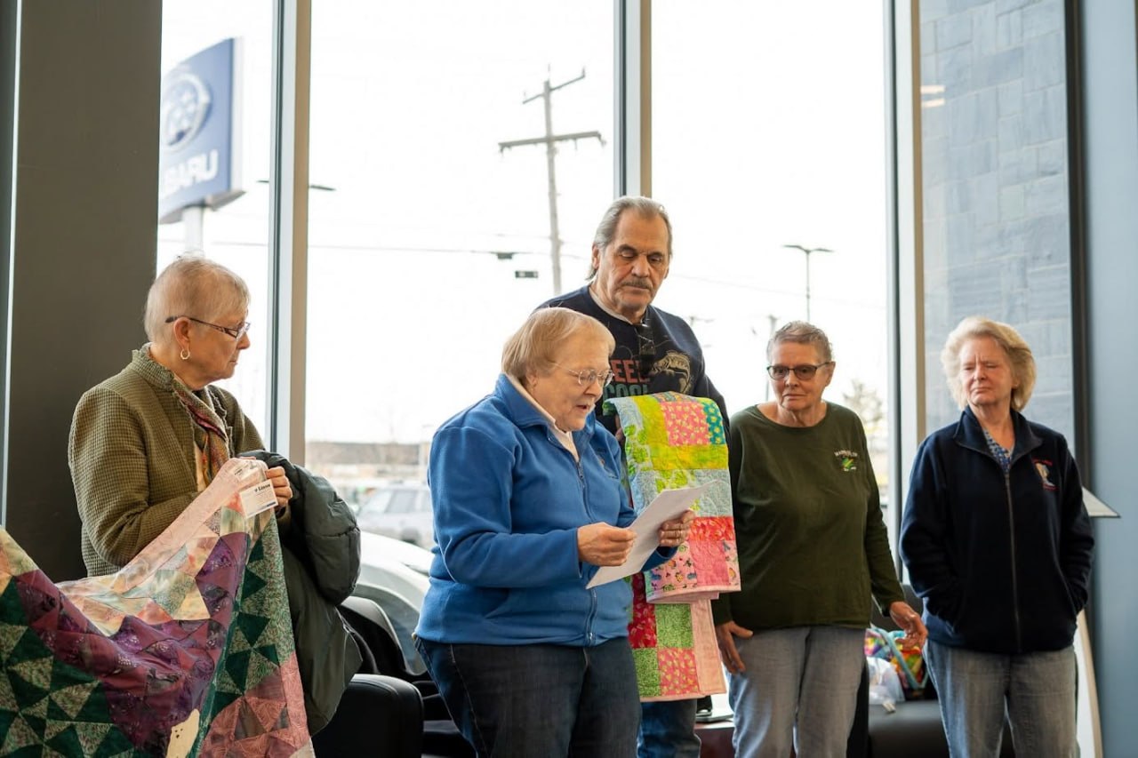 Quirk employees with Project Linus of Maine donation