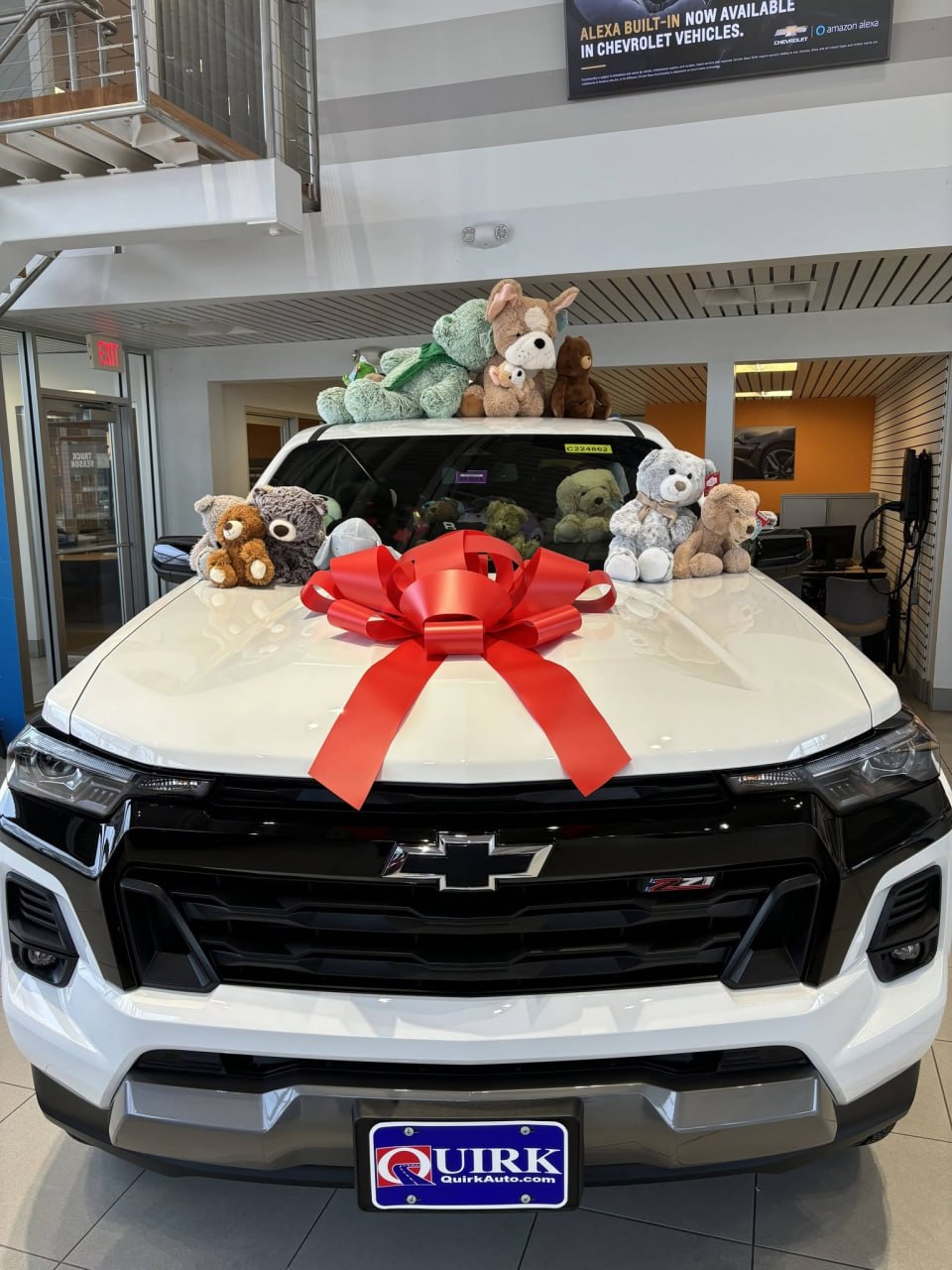 The front of the Colorado with a large red bow, stuffed animals lined across the hood and roof