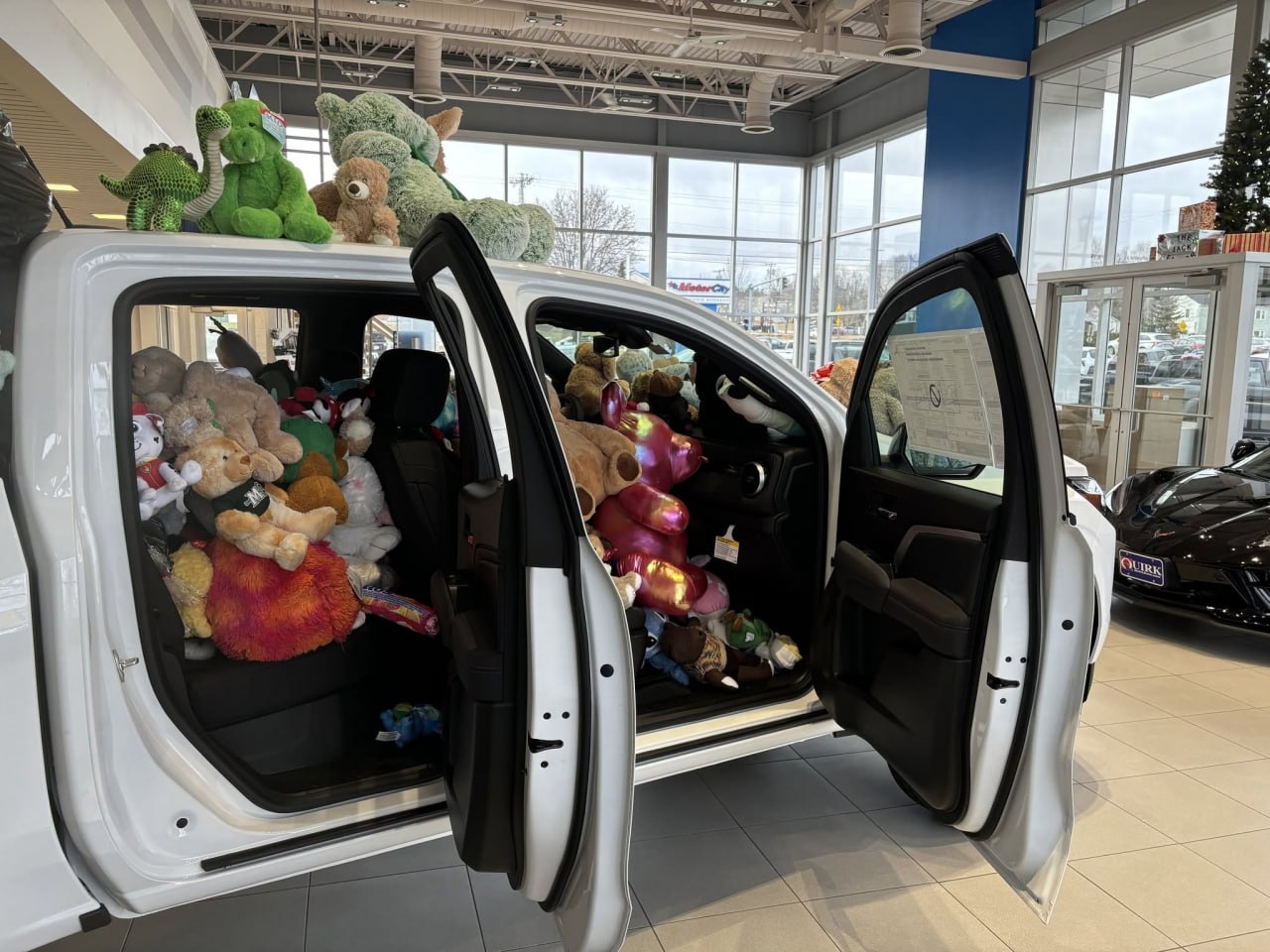 The truck's cab packed to the ceiling with donated teddy bears and stuffed animals